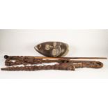 TWO AFRICAN CARVED HARDWOOD WALKING STICKS, one carved with balancing figures and an encapsulated