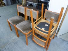 A SET OF FOUR DINING CHAIRS WITH UPHOLSTERED BACKS AND SEATS