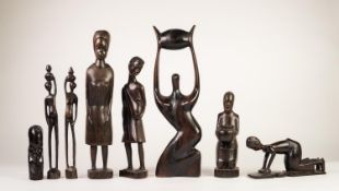 TWO AFRICAN CARVED HARDWOOD FIGURES OF WOMEN STANDING EACH WITH A CHILD IN A SLING, the larger