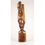 AFRICAN HARDWOOD TREE BRANCH CARVED AND POLISHED WITH TWO FEMALE HEADS, one above the other or as