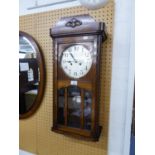 A WELLINGTON WALL CLOCK WITH CARVED OAK CASE, 8 DAYS MOVEMENT STRIKING THE ON THE HOUR AND HALF HOUR