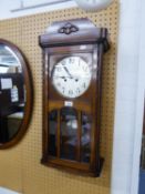 A WELLINGTON WALL CLOCK WITH CARVED OAK CASE, 8 DAYS MOVEMENT STRIKING THE ON THE HOUR AND HALF HOUR