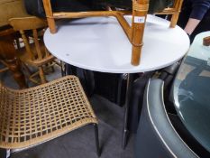 A CIRCULAR WHITE DINING TABLE RAISED ON CHROME LEGS (90cm diameter)