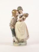LLADRO, SPANISH PORCELAIN GROUP OF A DUTCH GIRL AND BOY, she holding a basket of fruit, he leaning
