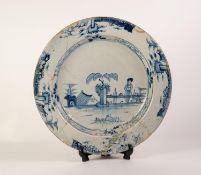 A LARGE EIGHTEENTH CENTURY LIVERPOOL DELFT PLATE, painted in blue in chinoiserie taste,