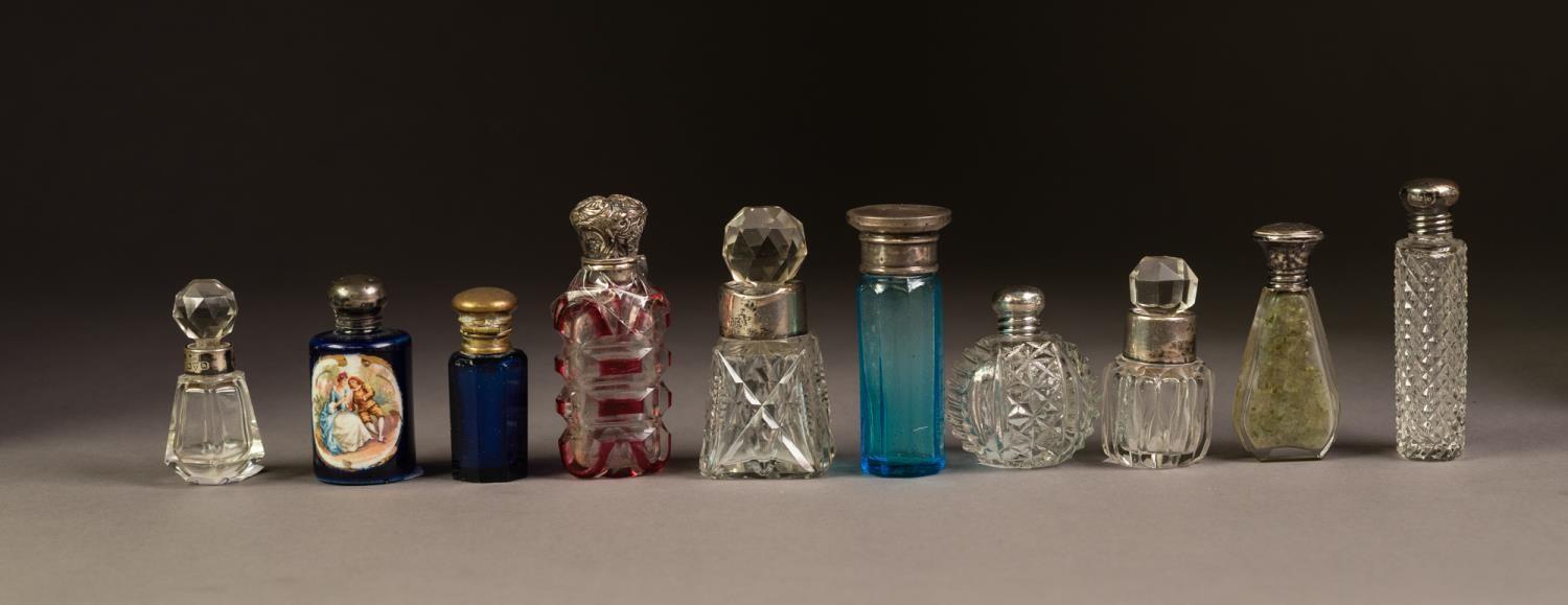 NINE VARIOUS GLASS PERFUME BOTTLES, either with silver coloured metal collars or screw-off tops,