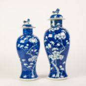 TWO SIMILAR LATE NINETEENTH CENTURY CHINESE PORCELAIN INVERTED BALUSTER SHAPE VASES, with covers,
