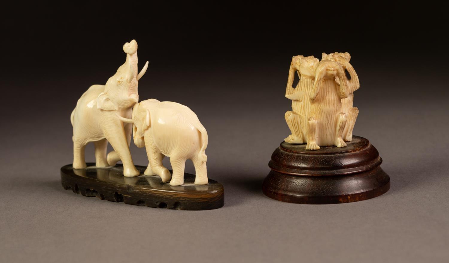 A SMALL CARVED IVORY MODEL OF TWO ELEPHANTS FIGHTING, on an elliptical horn base, 3 3/4" (9.5cm) - Image 3 of 3