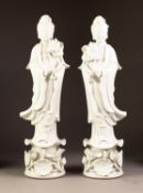 PAIR OF 20th CENTURY CHINESE PORCELAIN TALL BLANC-DE-CHINE FIGURES OF QUANYIN stading holding a