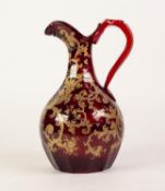 A FINE EARLY VICTORIAN PROBABLY ENGLISH RUBY GLASS JUG, the pear shape body cut with facets to the