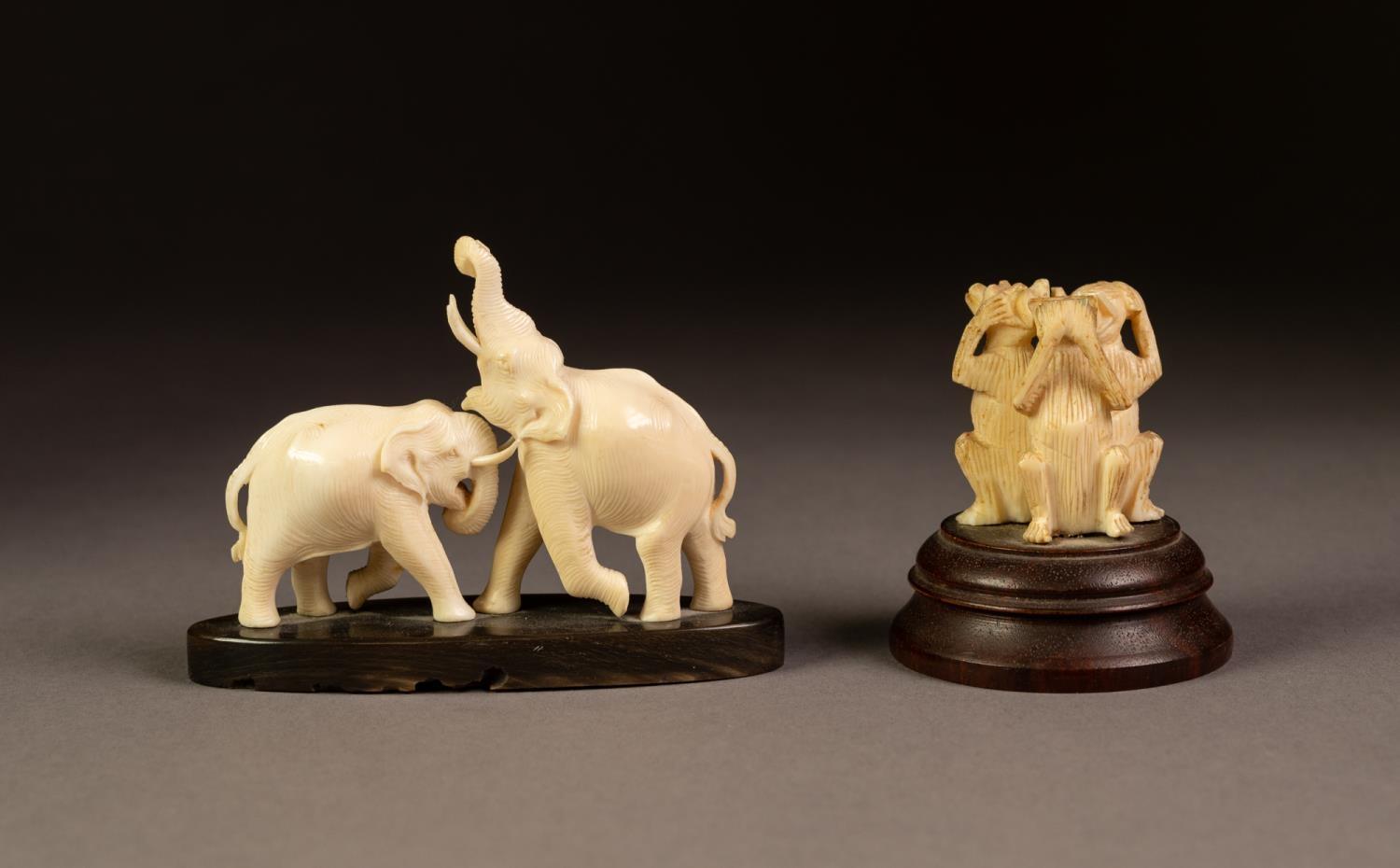 A SMALL CARVED IVORY MODEL OF TWO ELEPHANTS FIGHTING, on an elliptical horn base, 3 3/4" (9.5cm) - Image 2 of 3