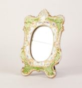 AN EARLY TWENTIETH CENTURY DRESDEN PORCELAIN WOODEN BACKED EASEL SUPPORT MIRROR, the oval plate