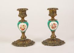PAIR OF LATE 19th CENTURY CAST GILT BRASS CANDLESTICKS, each with ovular porcelain stems, painted