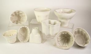 A COLLECTION OF 31 VICTORIAN AND LATER LARGE AND SMALLER EARTHENWARE MOSTLY WHITE GLAZED JELLY