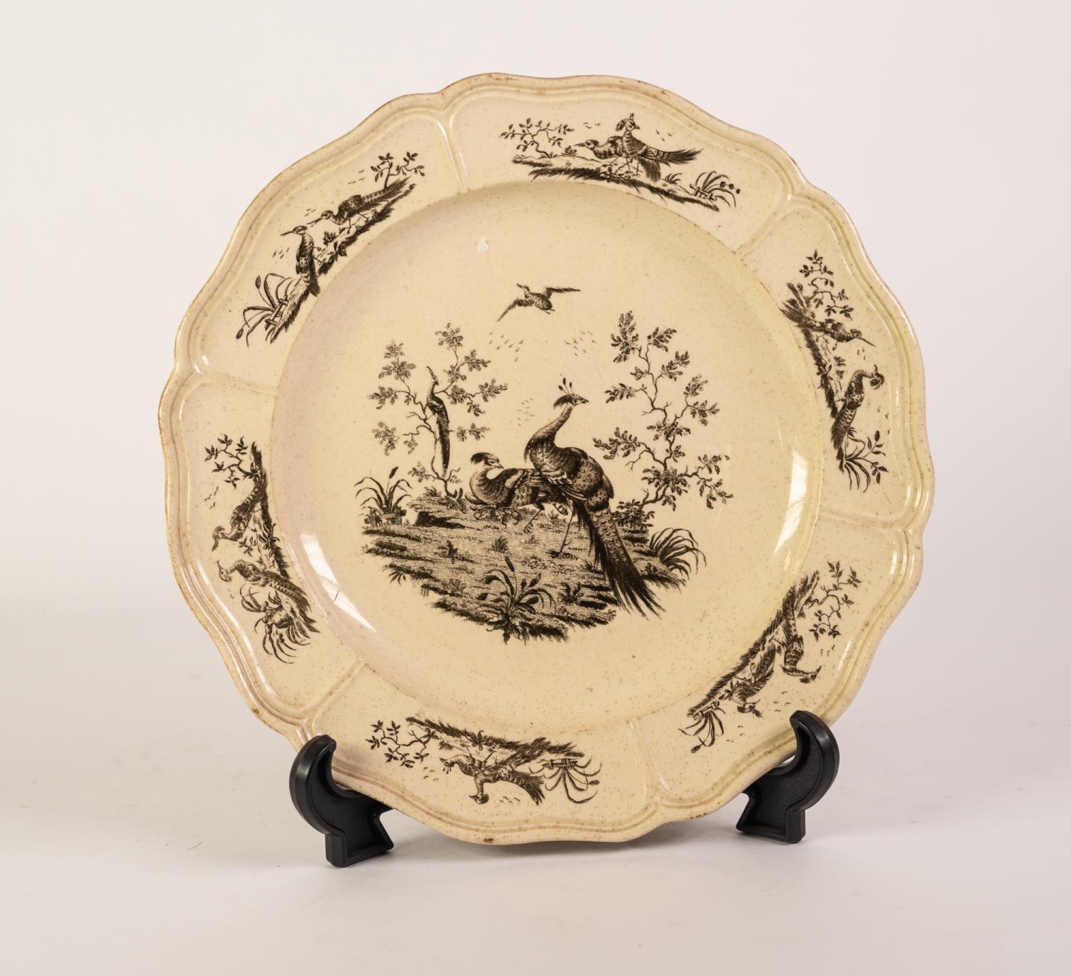 A CIRCA 1775 LIVERPOOL OR STAFFORDSHIRE CREAMWARE SCALLOPED PLATE, transfer printed in black with