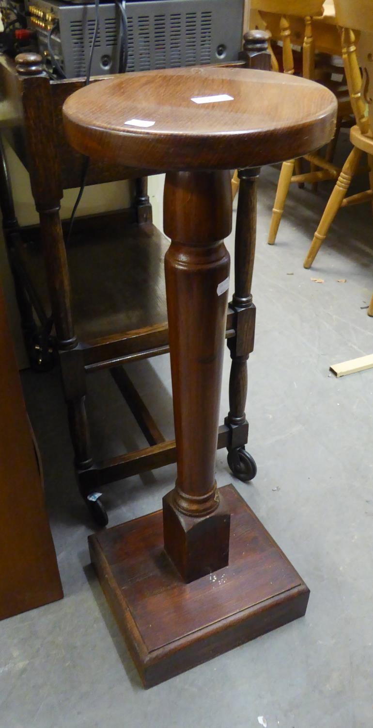 A MAHOGANY TALL PEDESTAL WITH CIRCULAR TOP, TAPERING COLUMN ON SQUARE BASE