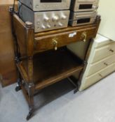 AN OAK TWO-TIER TEA TROLLEY, FITTED WITH A DRAWER