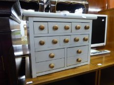 A WHITE PAINTED SPICE CHEST OF FOURTEEN SMALL DRAWERS, 1? 3 ½? WIDE, 1? HIGH