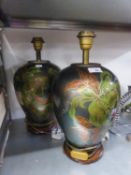 A PAIR OF DECORATED METAL OVULAR VASE TABLE LAMPS AND FABRIC SHADES