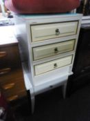 A WHITE FINISH THREE DRAWER BEDSIDE CHEST AND A BED TABLE AND A MIRROR (3)