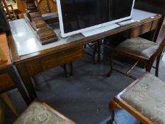 AN OAK OFFICE DESK WITH TWO DRAWERS, RAISED ON STRAIGHT SUPPORTS (MADE BY REMPLOY)