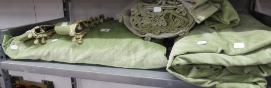 A PAIR OF GREEN PATTERNED VELVET WINDOW CURTAINS, LINED AND FRENCH HEADED AND WITH MATCHING TIEBACKS