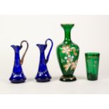 TWO SMALL SAPPHIRE BLUE GLASS ENAMELLED AND GILT DECORATED EWERS, a green tinted enamelled and