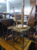 A HARDWOOD MILKING STOOL WITH OVAL PANEL SEAT, A SMALL MILKING STOOL AND A CANE TOP STOOL (3)