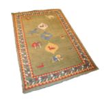 EASTERN CARPET with three small diamond shaped pole medallions featuring three animals, on a green