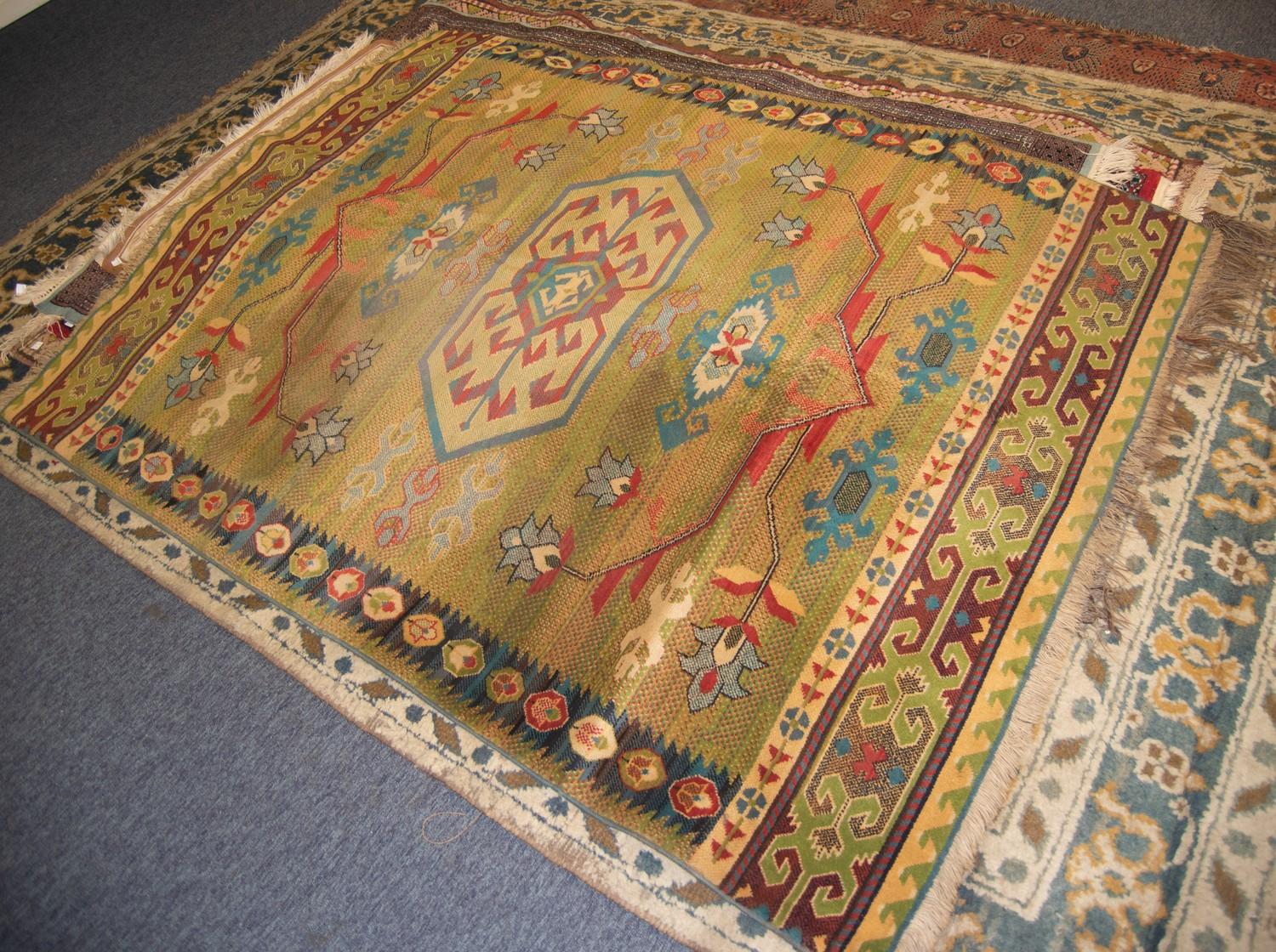 NEW ZEALAND, WOOL, MACHINE WOVEN BORDERED RUG of Caucasian design, having central medallion with