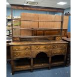 GEORGE III MONTGOMERYSHIRE OAK DRESSER, the open three shelf plate rack with two short drawers to