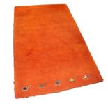EASTERN MACHINE WOVEN PLAIN ORANGE SMALL CARPET with row of five camels to the bottom edge, 6ft x