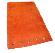 EASTERN MACHINE WOVEN PLAIN ORANGE SMALL CARPET with row of five camels to the bottom edge, 6ft x
