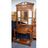 LATE VICTORIAN CARVED WALNUT HALLSTAND, the floral carved architectural pediment above two pair of