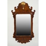 EARLY 20th CENTURY GEORGIAN REVIVAL WALNUT AND PARCEL GILT VERTICAL WALL MIRROR, the plate within