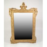 MODERN BAROQUE STYLE MOULDED GILT WALL MIRROR, the bevel edged plate within an ornate frame with