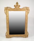 MODERN BAROQUE STYLE MOULDED GILT WALL MIRROR, the bevel edged plate within an ornate frame with