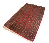 PAKISTAN BOKHARA RUG with two rows of guls on a crimson field 5ft x 3ft 1in (152.4 x 93.9cm) and