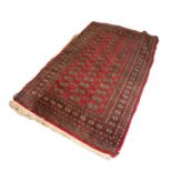 PAKISTAN BOKHARA RUG with two rows of guls on a crimson field 5ft x 3ft 1in (152.4 x 93.9cm) and