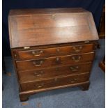 GEORGE III OAK BUREAU, of typical form, the interior fitted with pigeon holes and short drawers