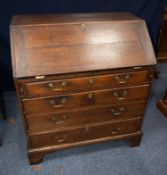 GEORGE III OAK BUREAU, of typical form, the interior fitted with pigeon holes and short drawers