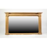 VICTORIAN OVER MANTEL MIRROR, the gilt frame in architectural style with large paterae to each top