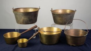 FOUR BRASS JAM PANS with cast iron swing handles, 11? (28cm) diameter and smaller, together with TWO