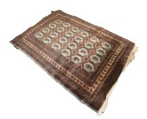 FINELY KNOTTED PAKISTAN BOKHARA RUG, with silky pile and four rows of hexagonal pale blue guls, each