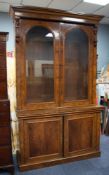 GOOD VICTORIAN BURR WALNUT BOOKCASE, the moulded cornice above a pair of cupboard doors, arched