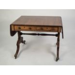 ANTIQUE REGENCY STYLE MAHOGANY SOFA TABLE, the plain reeded edge drop-flap top above two frieze