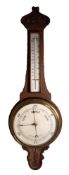 EARLY TWENTIETH CENTURY CARVED OAK BANJO ANEROID BAROMETER, with mercury thermometer to the trunk,