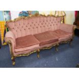 MODERN CARVED GILTWOOD THREE SEATER SETTEE, the ornate scroll carved and pieced show wood frame