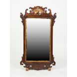 EARLY 20th CENTURY GEORGIAN REVIVAL WALNUT AND PARCEL GILT VERTICAL WALL MIRROR, the plate within