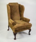 GEORGE III STYLE LARGE WINGED FIRESIDE ARMCHAIR, upholstered and covered in embossed green, blue and